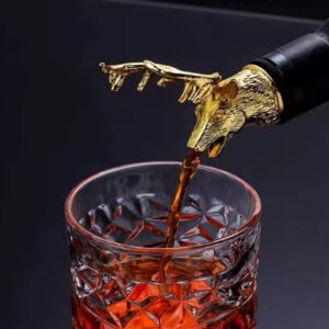 A glass cover with a metallic deer head design