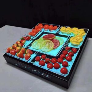 A color-changing LED fruit serving base